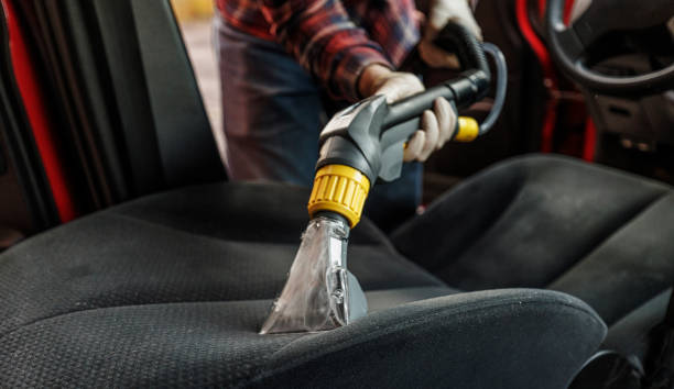 Hot-water extraction machine deep cleaning a fabric car seat during an interior detail in Springfield, MO